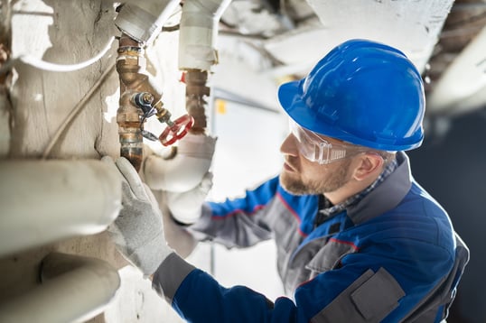 plumber checking valve on plumbing maintenance checklist