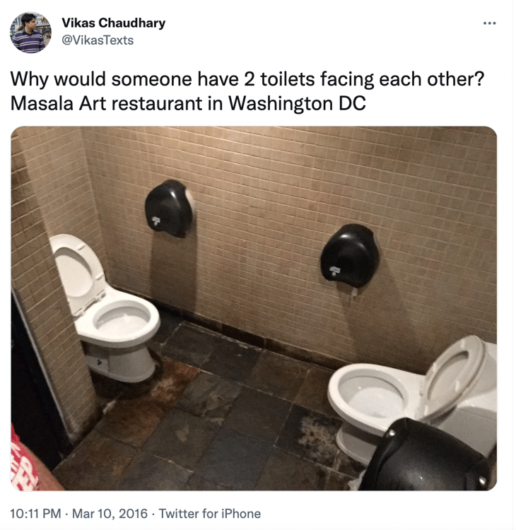dual toilets in a bathroom stall