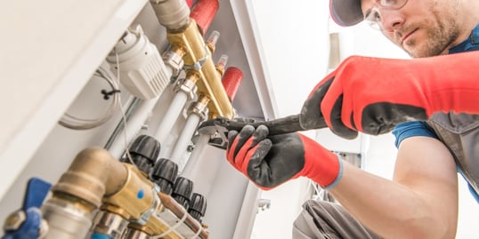 man-tightening-plumbing-connection