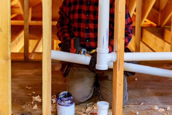 plumber addressing commercial plumbing problem