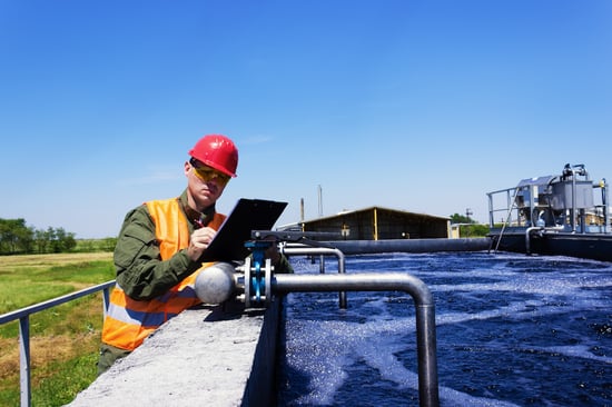 plumber assessing valve at water treatment facility