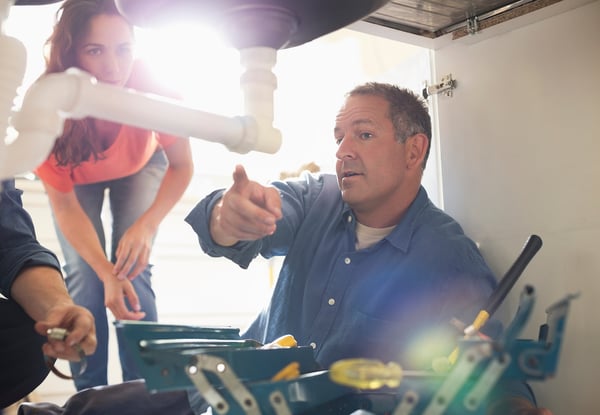 plumber repairing broken water pipe