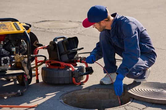 plumber doing pipe inspections for trenchless sewer repair