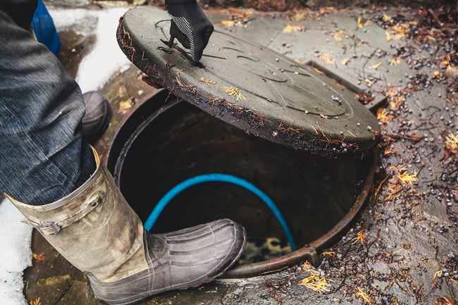 plumbers accessing a main sewer drain