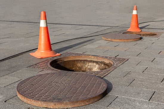 safety cones around manhole for sewer line inspection