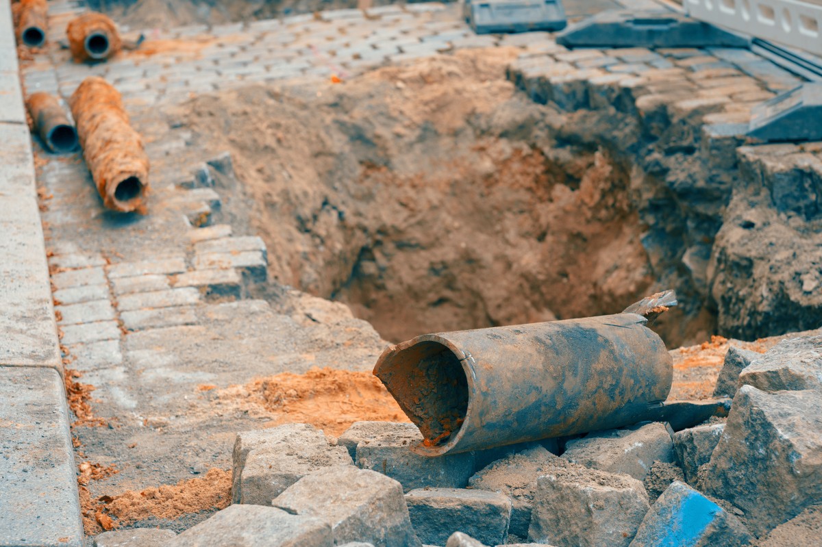 broken sewer pipes on a street